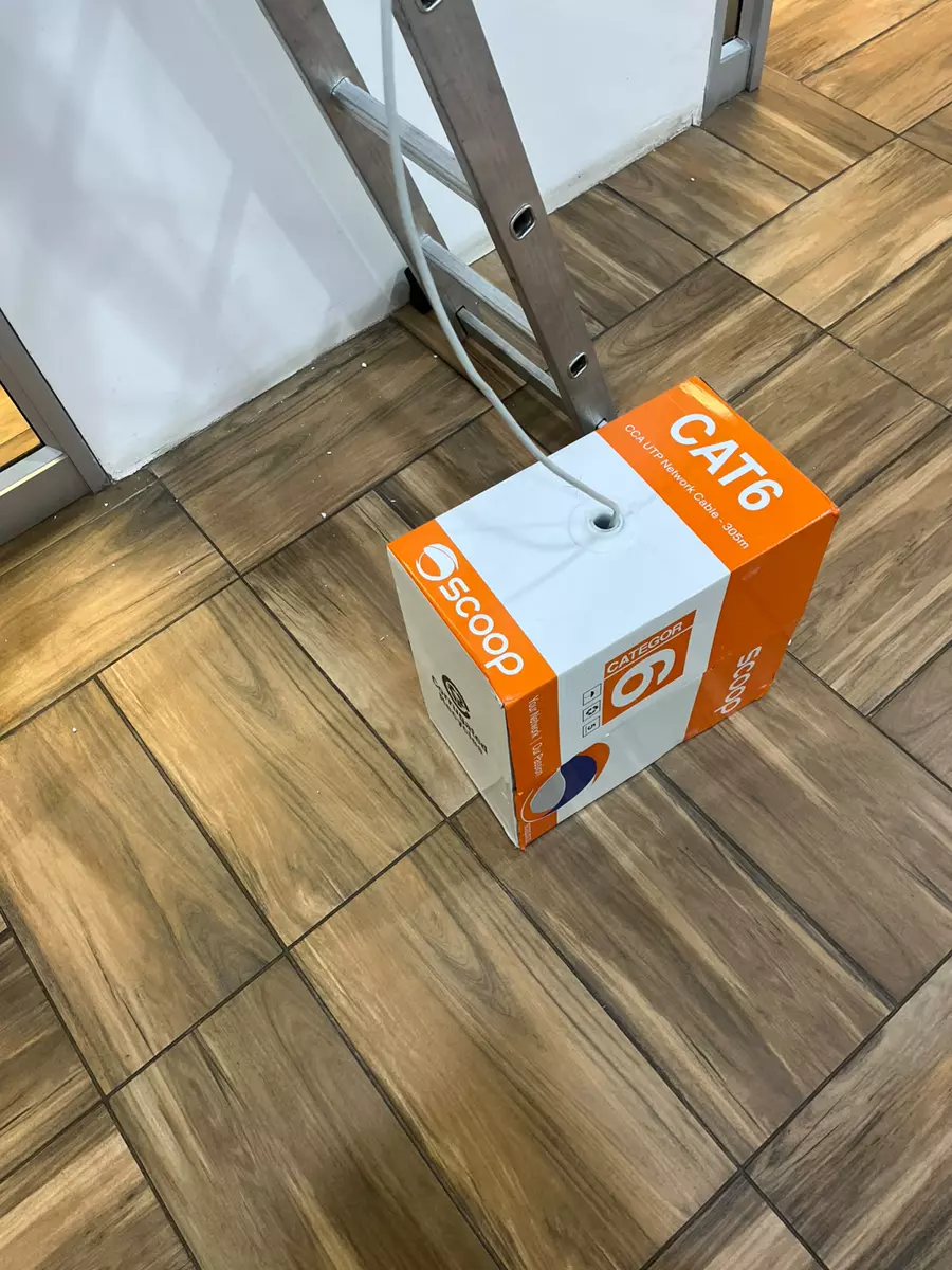 CAT6 network cable box on a tiled floor